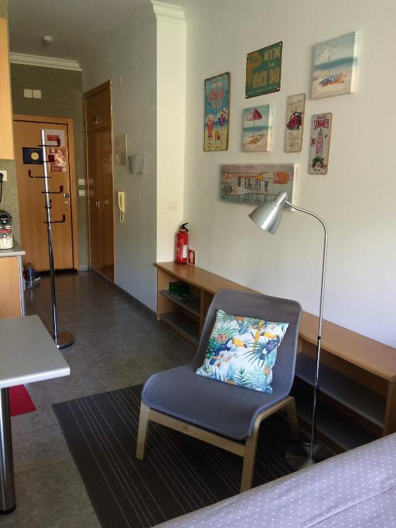 a room with a chair and a desk and a lamp at Ericeira Surf and Sun in Ericeira