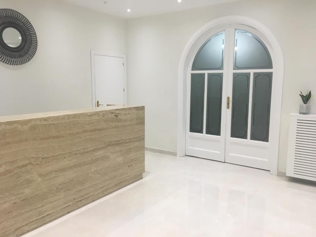 a white room with a door and a window at Rincón de Gran Vía in Madrid