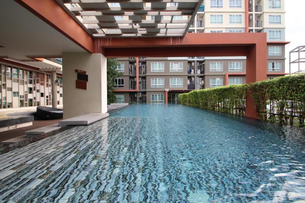 a swimming pool in the middle of a building at Dcondo Kathu Patong Phuket by Suna in Kathu