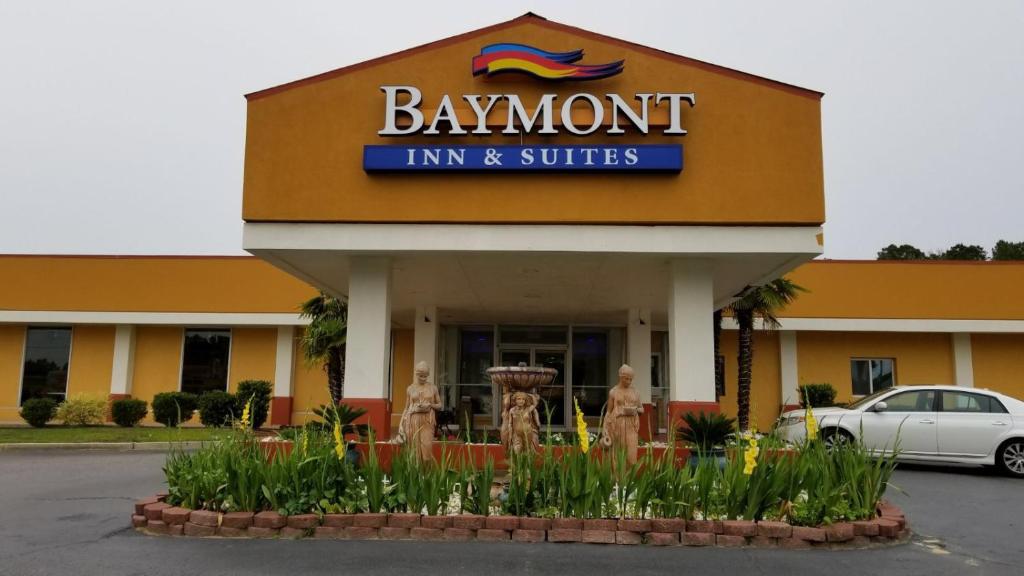 a bawdon inn and suites sign in front of a building at Baymont by Wyndham Walterboro in Walterboro