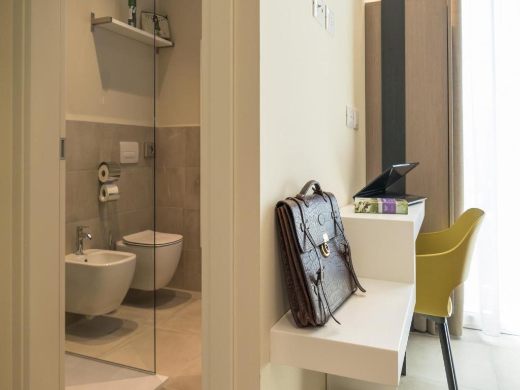 a bag sitting on a table in a bathroom at Hotel Buena Onda in Peschiera del Garda
