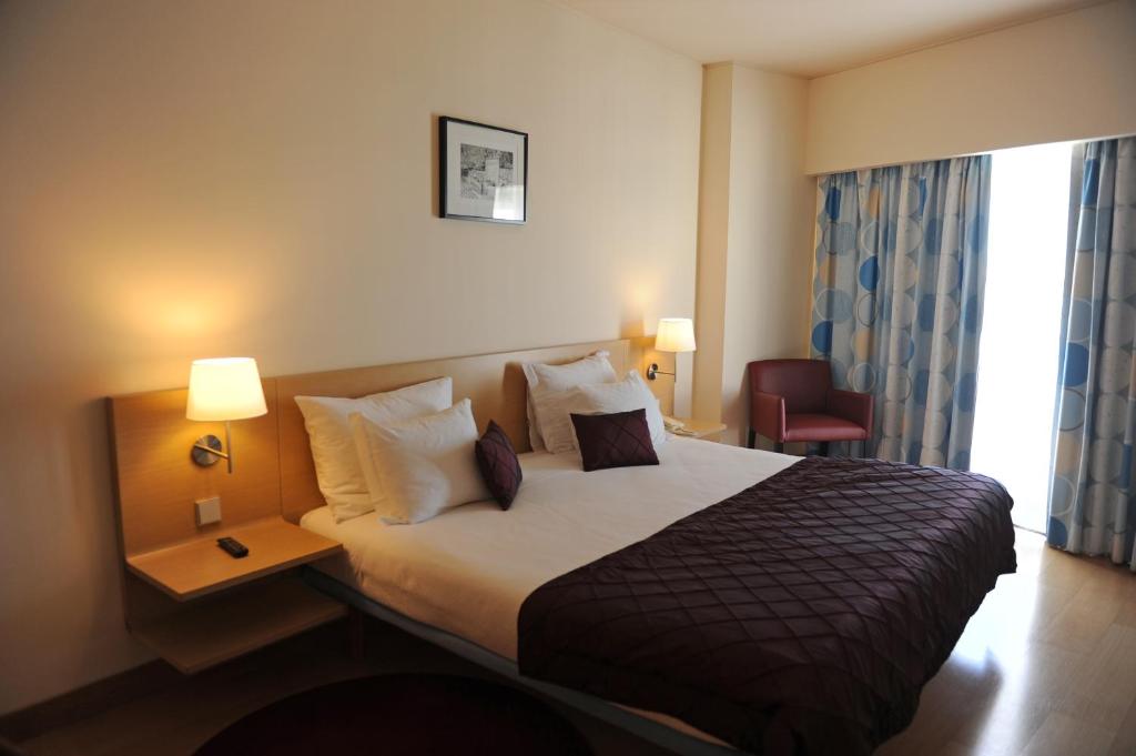 Uma cama ou camas num quarto em Hotel Turismo De Trancoso