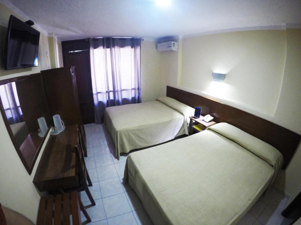 Postel nebo postele na pokoji v ubytování Hotel Oriente