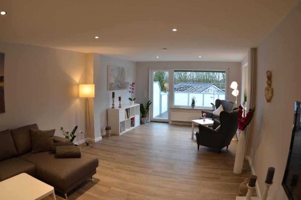 a living room with a couch and a chair at Ferienhaus Rosi in Kiel