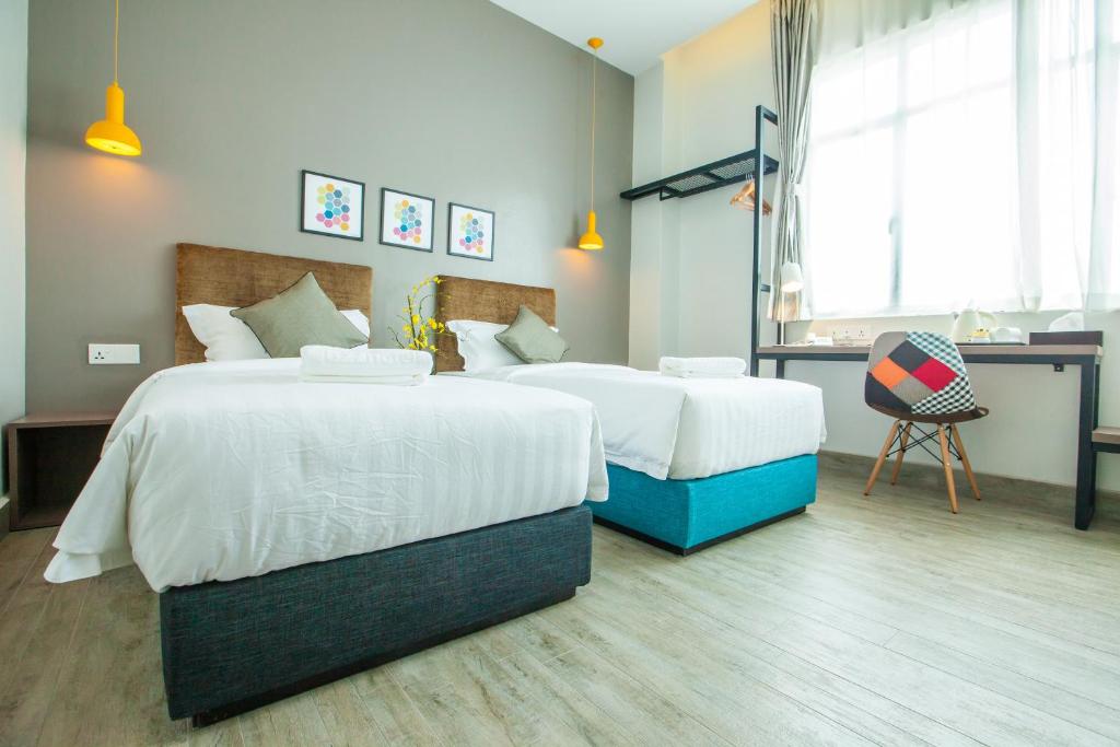Postel nebo postele na pokoji v ubytování Bzz Hotel Skudai