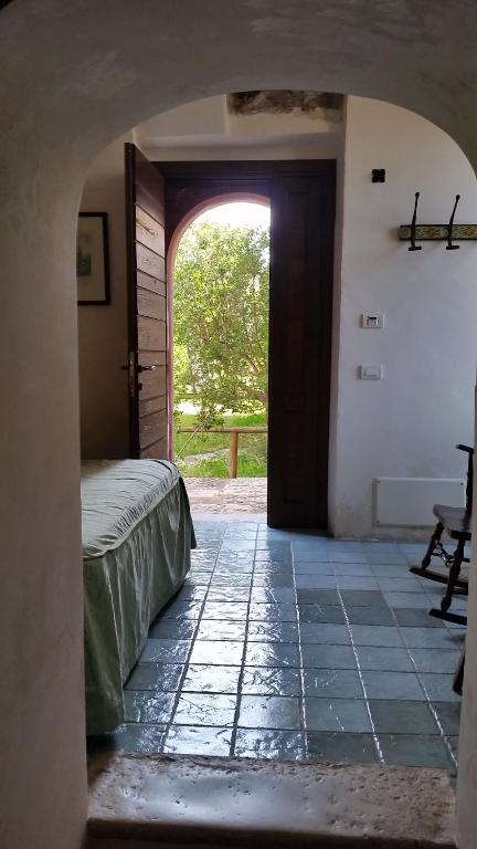 a room with a bed and an open door at Agriturismo La Torre Rossa in Itri