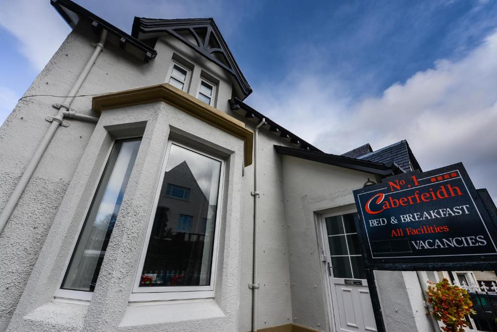 a white building with a sign in front of it at No. 1 Caberfeidh in Fort William