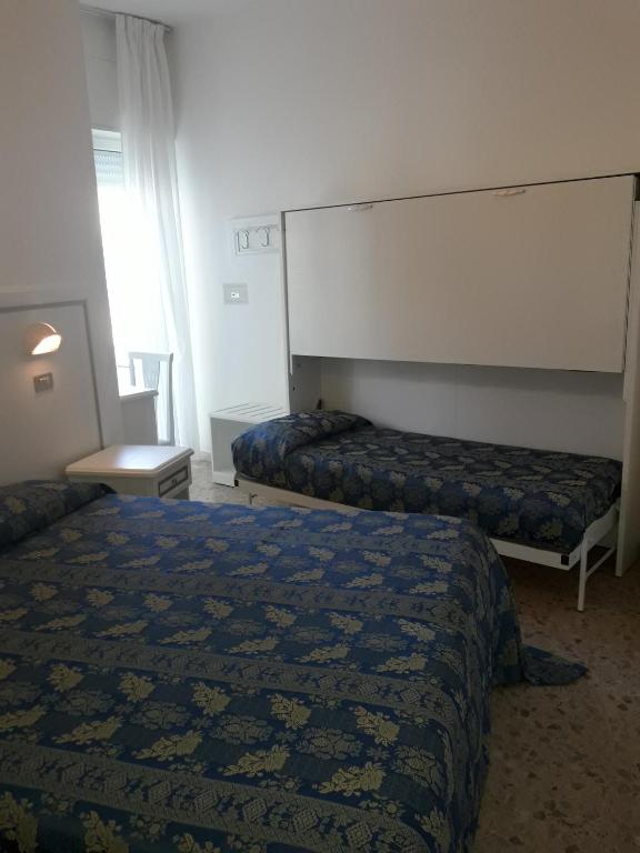 A bed or beds in a room at Hotel Imperiale