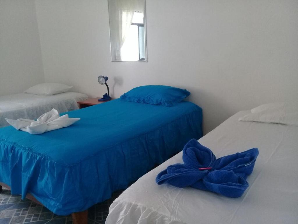 Postel nebo postele na pokoji v ubytování Hostal Insular
