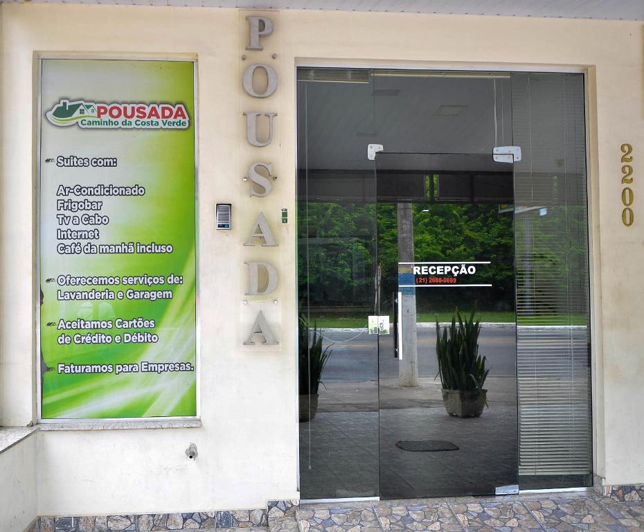 a glass door of a building with a sign on it at Caminho da Costa Verde in Itaguaí