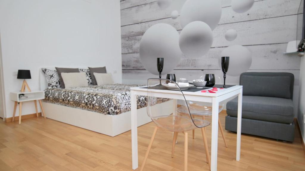 a bedroom with a bed and a table and a chair at P&D Apartments Navigli Ripa Ticinese in Milan