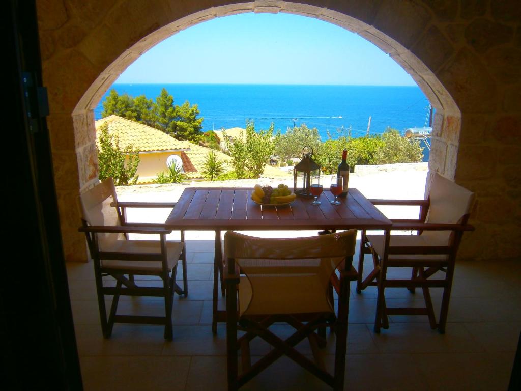 a dining room table with a view of the ocean at Villa Mare Studios in Skinária