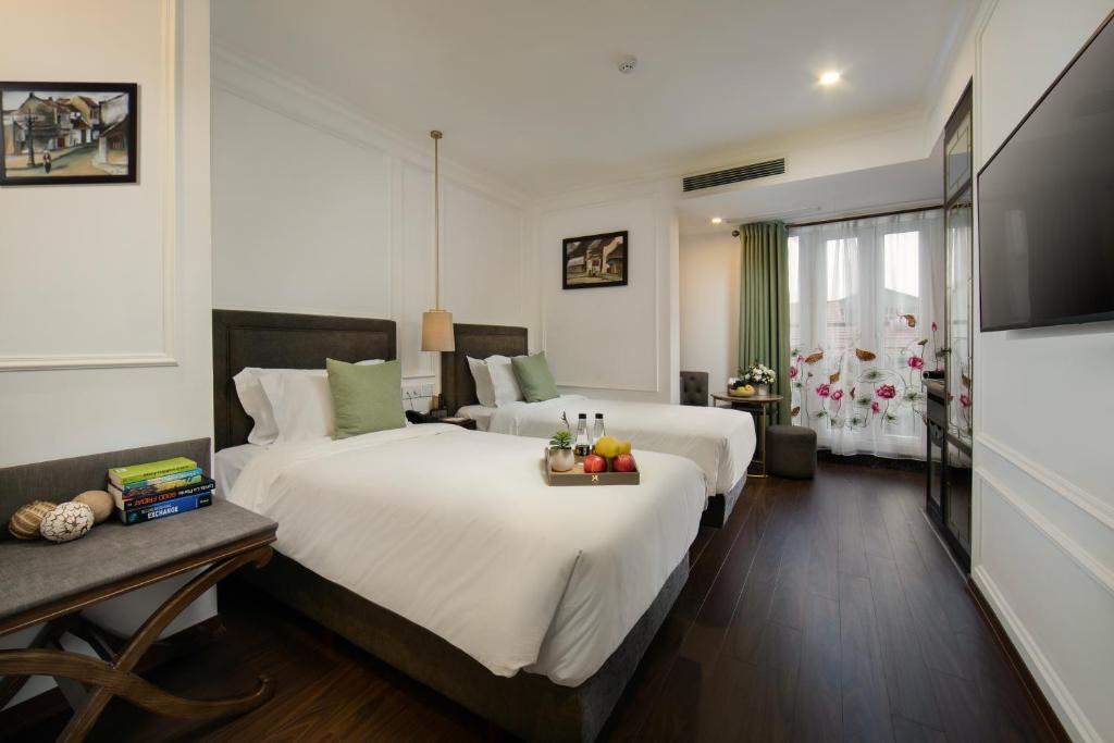 Postel nebo postele na pokoji v ubytování Hanoi Allure Hotel