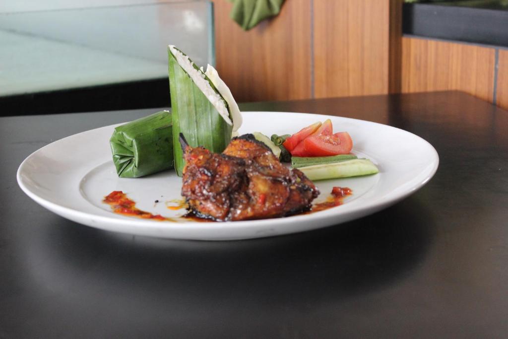 a white plate of food on a table at Kyriad Hotel Airport Jakarta in Tangerang