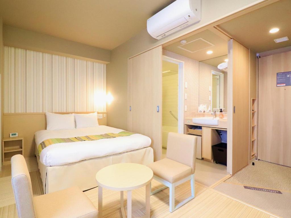 Postel nebo postele na pokoji v ubytování Hiyori Hotel Maihama