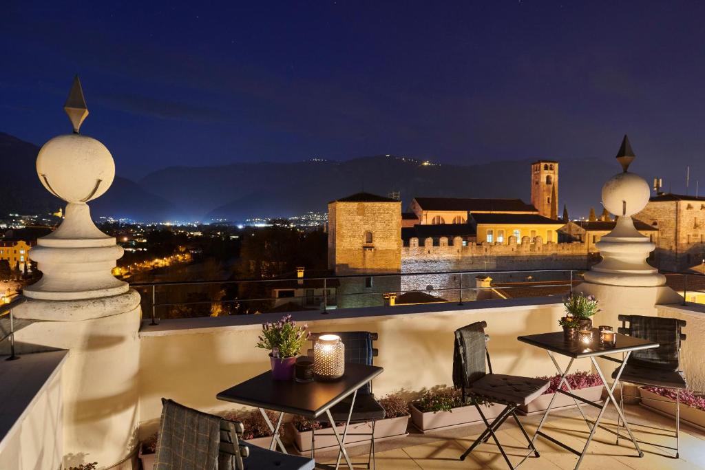 a view of a city from a balcony at night at Terraglio Rooms in Bassano del Grappa