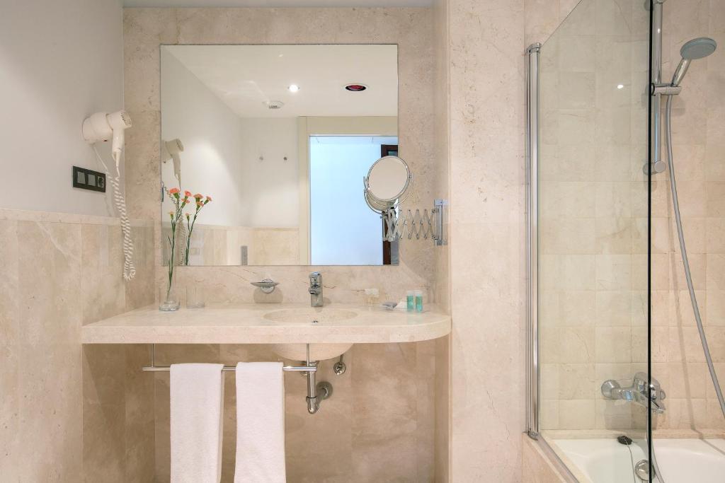 a bathroom with a sink and a shower at Hipotels Playa La Barrosa - Adults Only in Chiclana de la Frontera