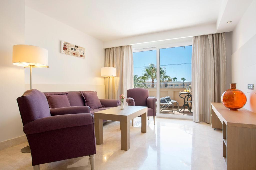 a living room with a couch and a table at Hipotels Playa La Barrosa - Adults Only in Chiclana de la Frontera