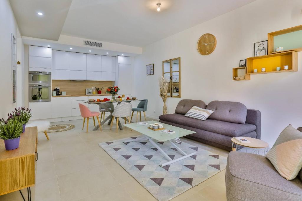 a living room with a couch and a table at MY CASA FRANCE 82 TP - Terrace AC & Parking in Nice