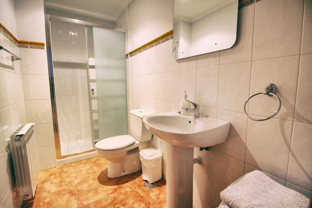 a bathroom with a sink and a toilet at Apartamentos La Fuente de Enmedio in Suances