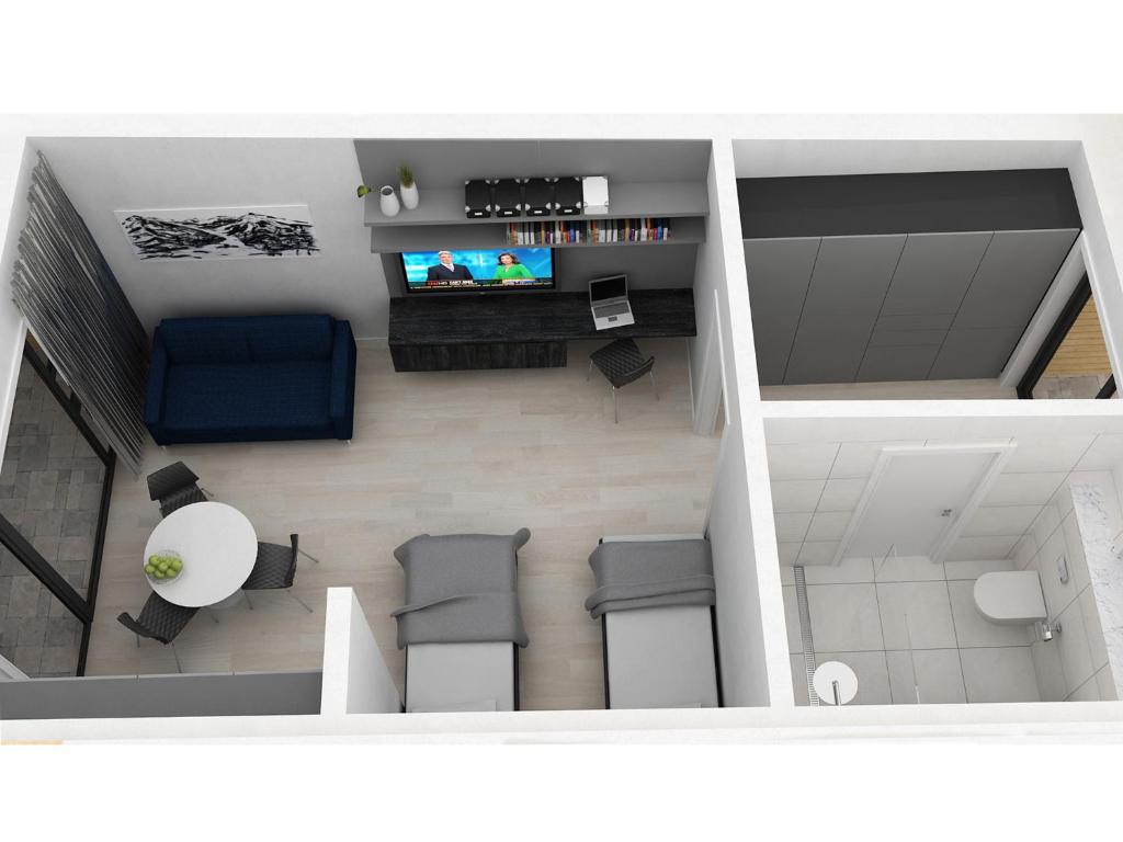 TV a/nebo společenská místnost v ubytování Black Beach Suites