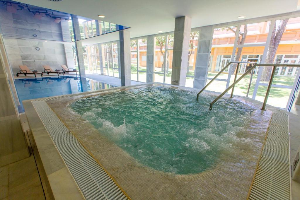 a hot tub in the middle of a building at Hipotels Playa La Barrosa - Adults Only in Chiclana de la Frontera