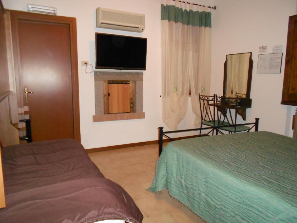 Postel nebo postele na pokoji v ubytování B&B La Quercia
