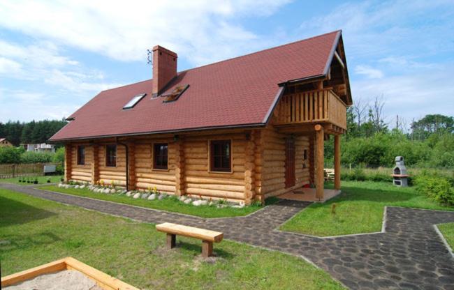 Cabaña de madera grande con techo rojo en Domy z bali Debina en Debina