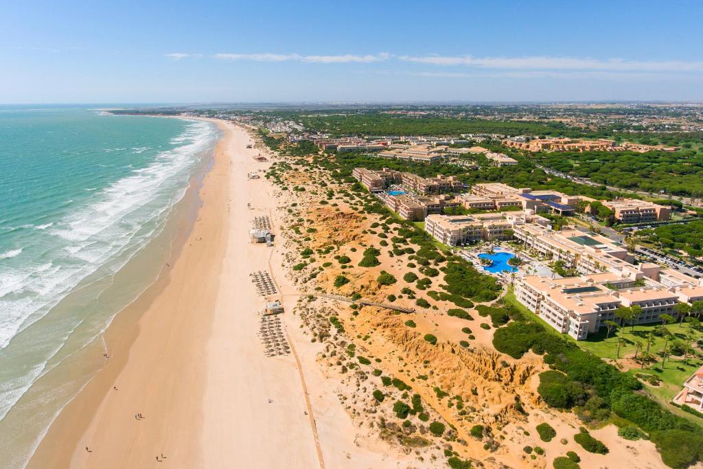 an aerial view of a beach with condos at Hipotels Playa La Barrosa - Adults Only in Chiclana de la Frontera
