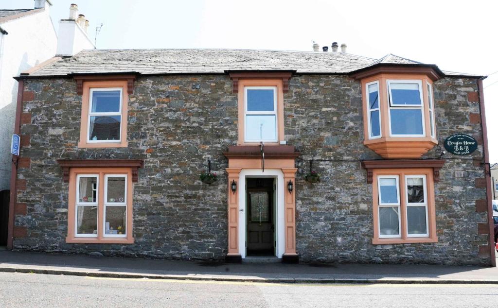 a brick house with a door on a street at Douglas House in Castle Douglas