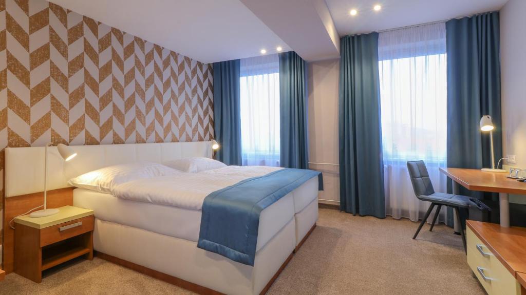 Posteľ alebo postele v izbe v ubytovaní Hotel Karpatia
