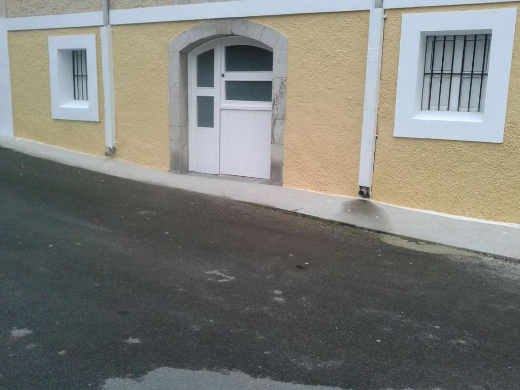 a building with a white door on the side of it at Apartamento en Llanes in Llanes