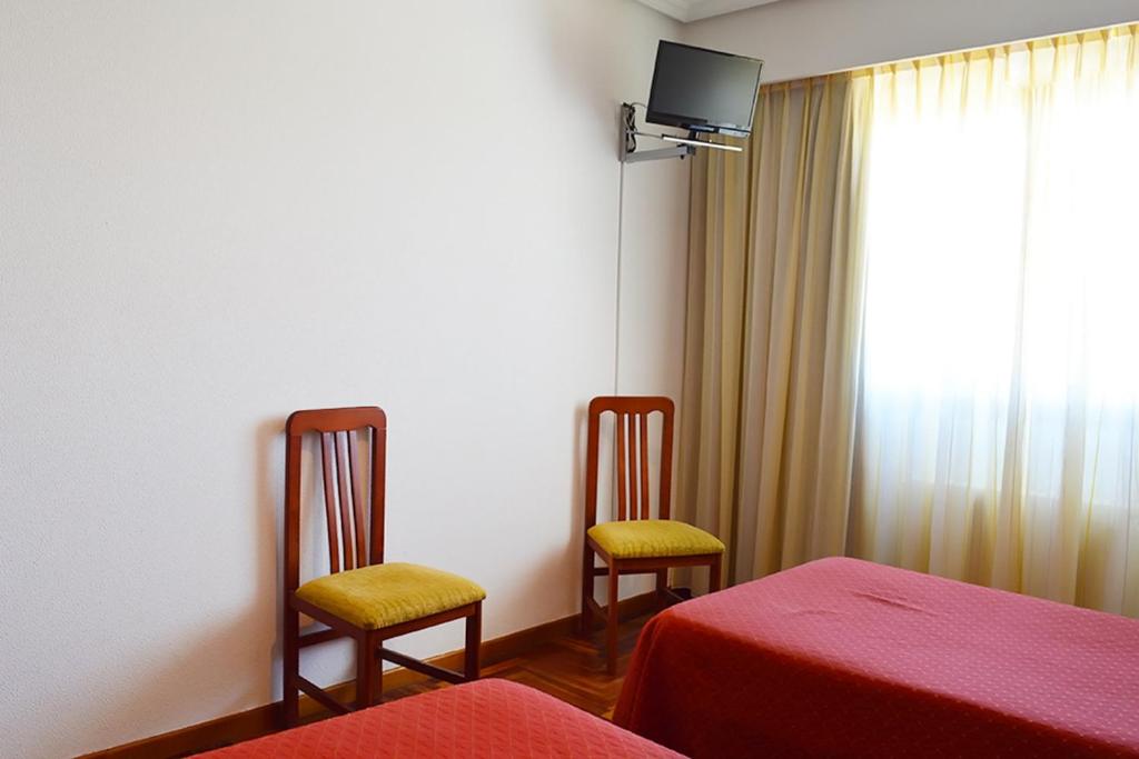 Postel nebo postele na pokoji v ubytování Hotel Os Caracoles