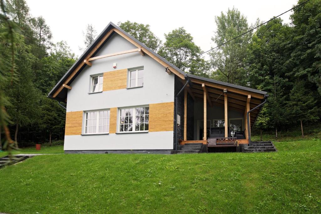 una casa con un ampio giardino con erba verde di Ostoja a Rzyki