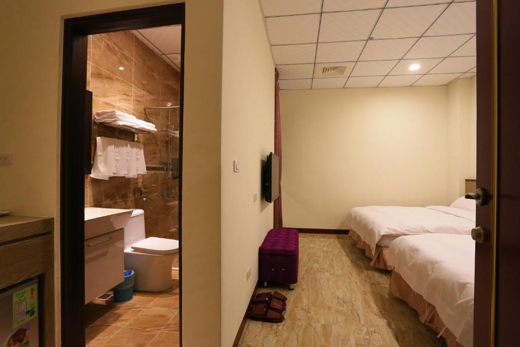 Postel nebo postele na pokoji v ubytování ChangJu Hotel-附免費停車位