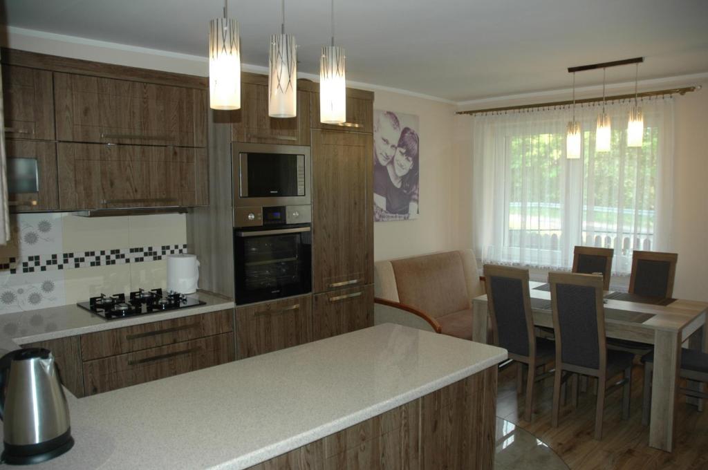 uma cozinha com uma mesa e uma sala de jantar em Apartament Beata em Jastrzebia Gora