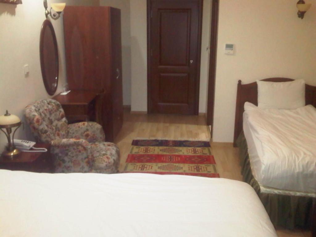 Postel nebo postele na pokoji v ubytování Basileus Hotel