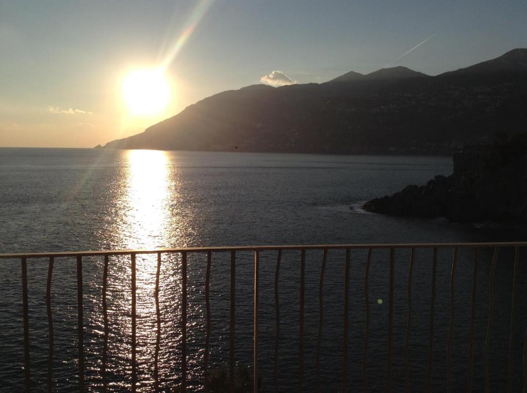 a view of the sun setting over the water at Villa Malù Amalfi Coast in Maiori
