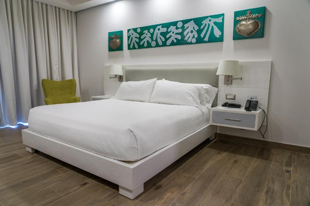Postel nebo postele na pokoji v ubytování Satama Hotel