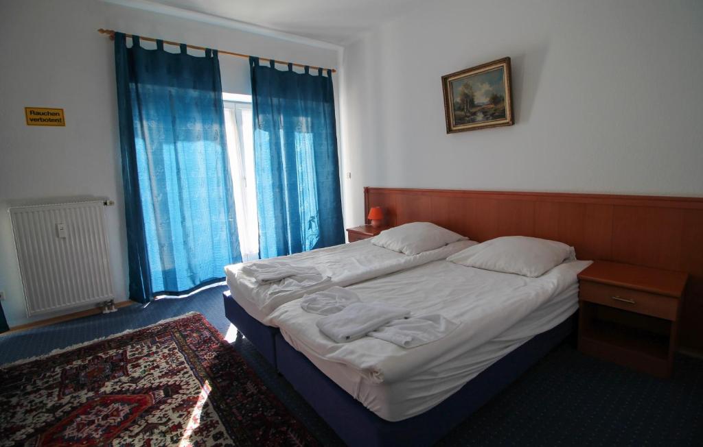 a bedroom with a bed and a large window at Hotel Ahrberg Viertel in Hannover