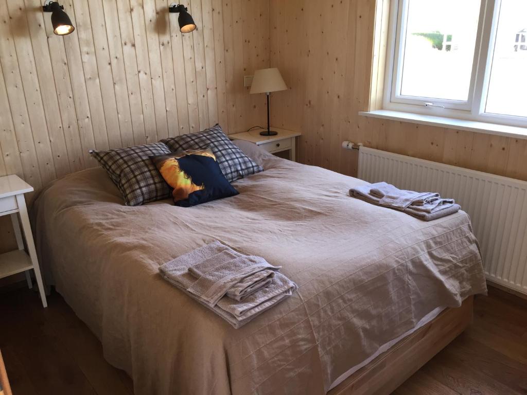ein Schlafzimmer mit einem Bett mit zwei Handtüchern darauf in der Unterkunft Sodulsholt Cottages in Sodulsholt