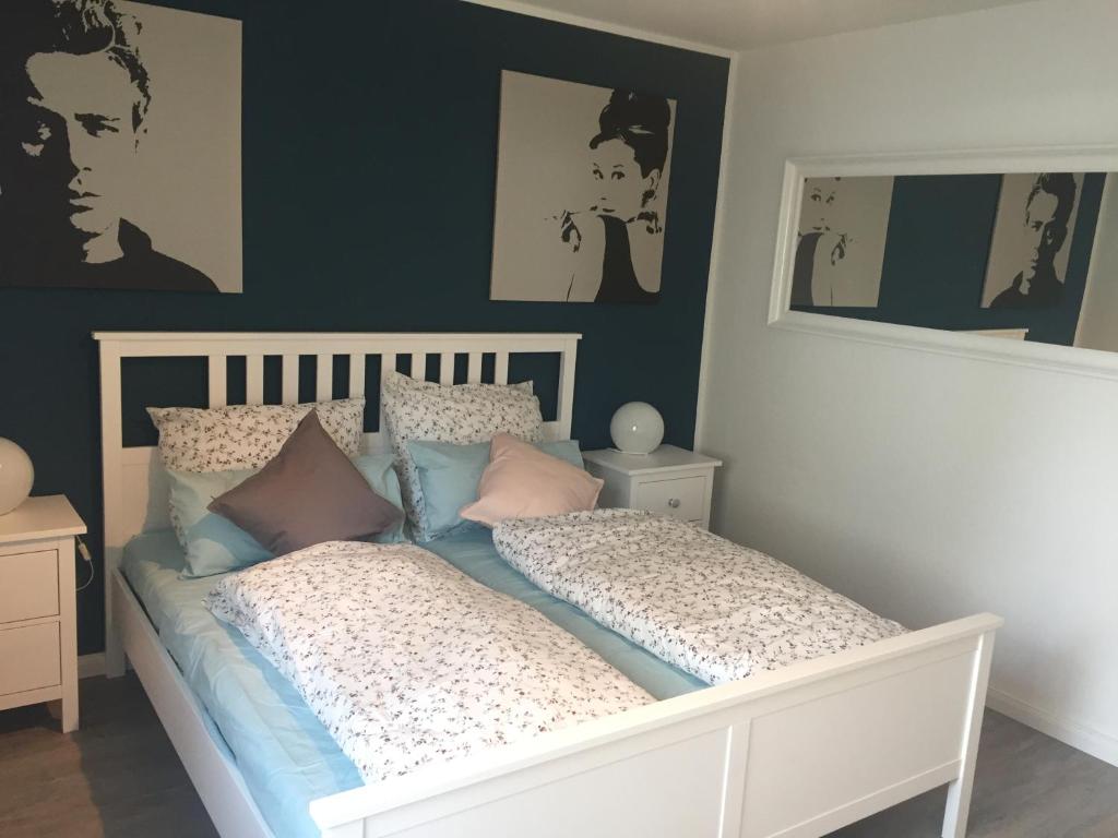 a bedroom with a white bed with pillows at Wilschenbruch in Lüneburg