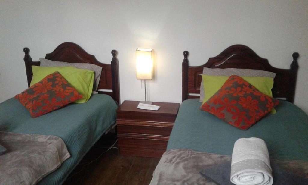 A bed or beds in a room at Patio das Flores