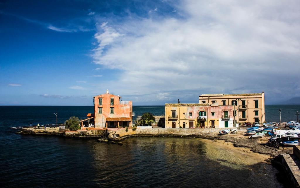a group of buildings next to the water at B&B Flavilla in Santa Flavia
