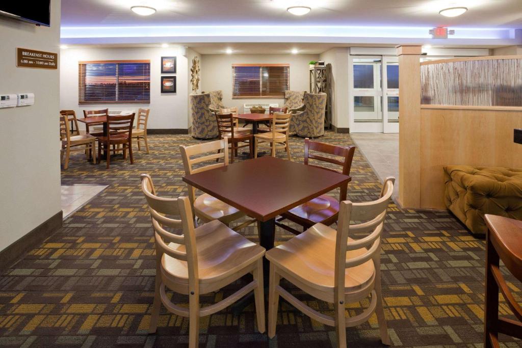 a dining room with a table and chairs at AmericInn by Wyndham Sibley in Sibley