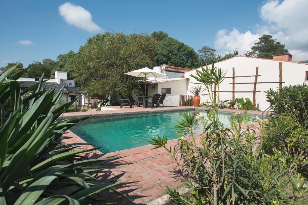 a swimming pool in front of a house at B&B Casa Hernández in San Lorenzo