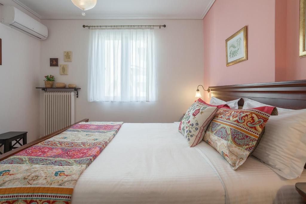 a bedroom with a large bed with pillows on it at Athens charming flat 10 min away from Acropolis by metro in Athens