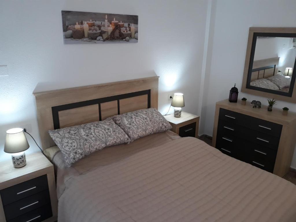 Łóżko lub łóżka w pokoju w obiekcie Apartamento Vacacional