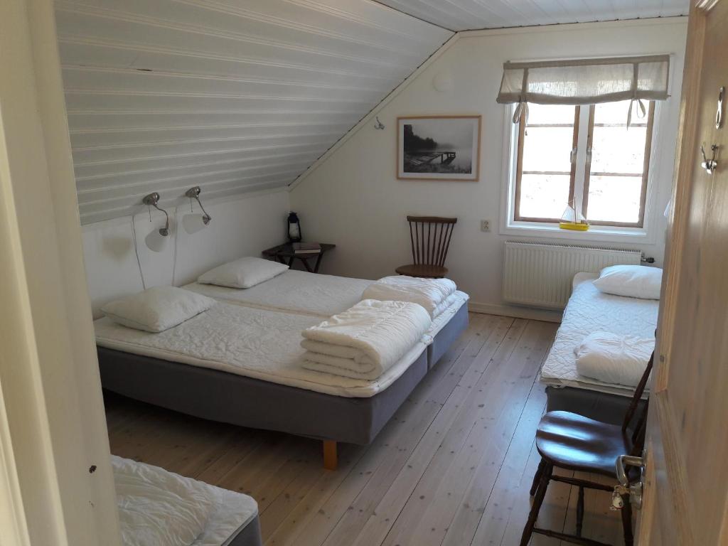 a bedroom with two beds and a window at STF Möja Vandrarhem in Möja