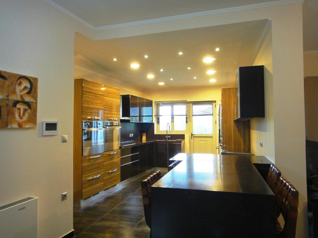 a kitchen with a large wooden table and cabinets at Villa Lydia in Nydri